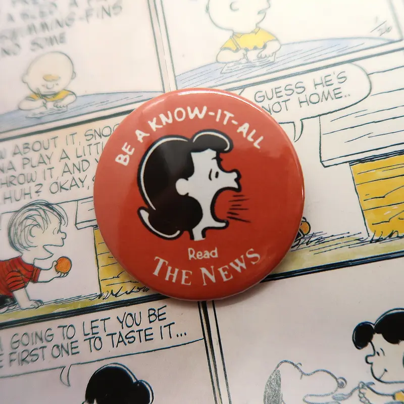 Snoopy/Peanuts Comics Vintage Lucy van Pelt "Read the News" Can Badge
